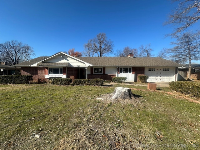 ranch-style home with a front lawn and a garage