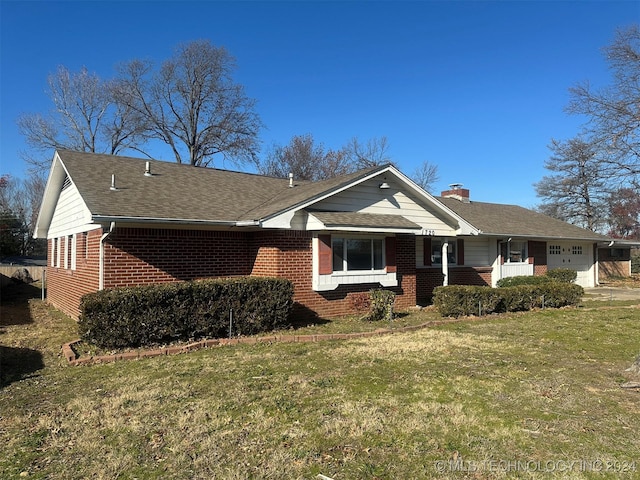 ranch-style home with a garage and a front lawn