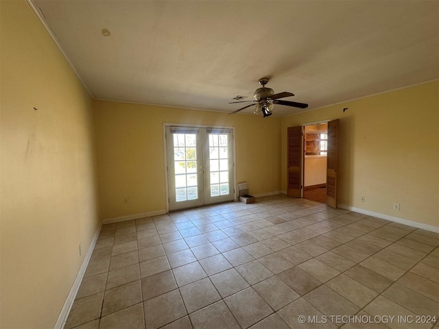 tiled spare room with ceiling fan, french doors, and crown molding