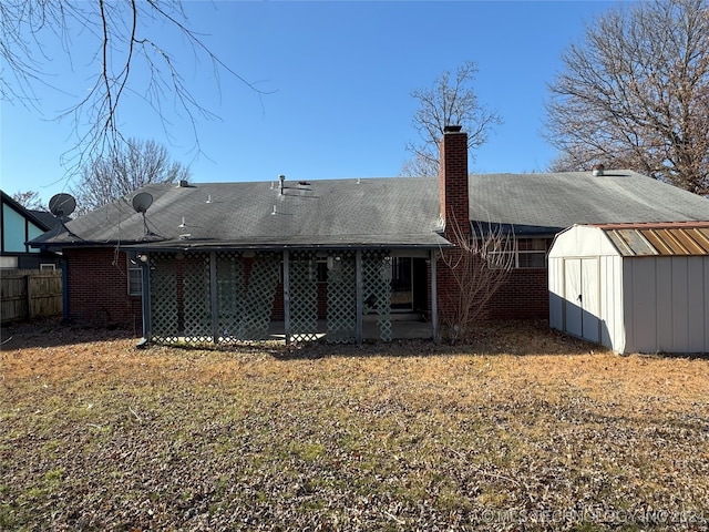 back of property with a yard and a storage unit