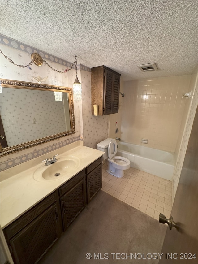 full bathroom featuring tile patterned floors, vanity, a textured ceiling, toilet, and tiled shower / bath