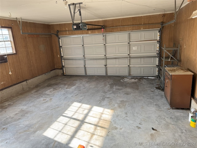 garage with wood walls and a garage door opener