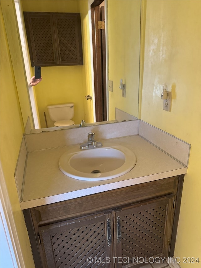 bathroom featuring vanity and toilet