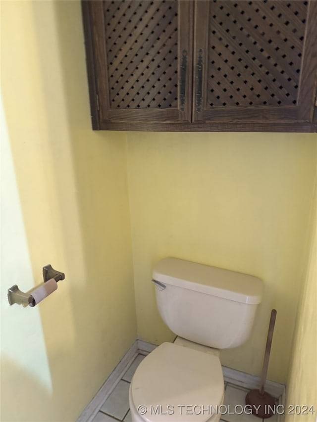 bathroom with tile patterned flooring and toilet