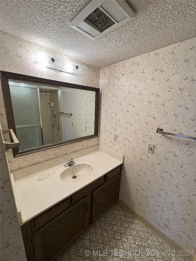 bathroom featuring vanity, a textured ceiling, and tile patterned flooring