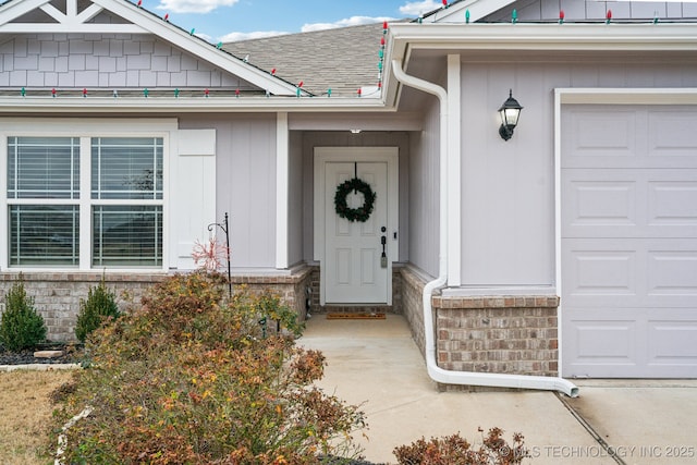 view of exterior entry with a garage