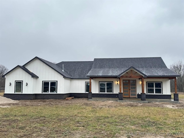 view of front facade featuring french doors and a front yard