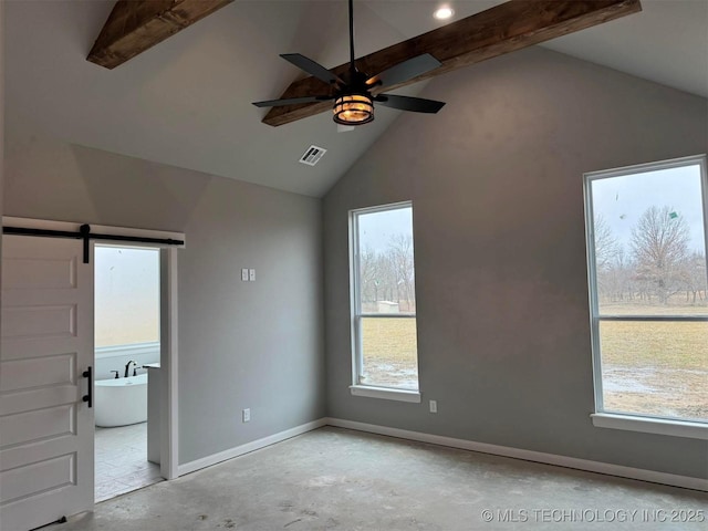 unfurnished bedroom with multiple windows, beam ceiling, high vaulted ceiling, and a barn door