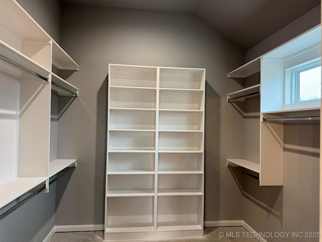 walk in closet featuring lofted ceiling