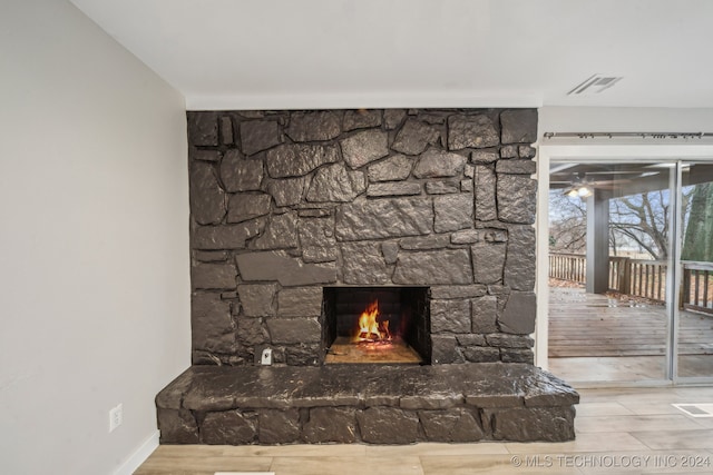 details with hardwood / wood-style flooring, ceiling fan, and a fireplace