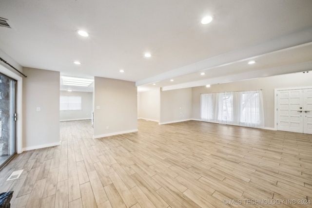 interior space featuring recessed lighting, light wood-type flooring, and baseboards