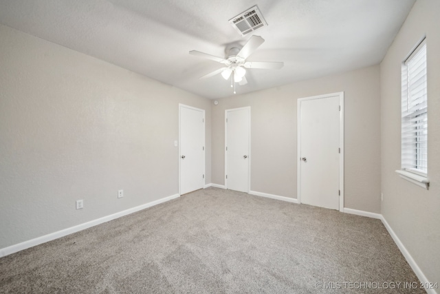 empty room featuring visible vents, baseboards, plenty of natural light, and carpet flooring