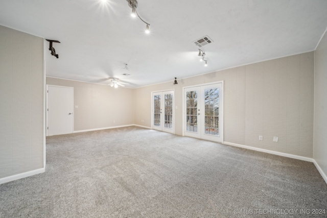 unfurnished room with carpet, ceiling fan, and crown molding