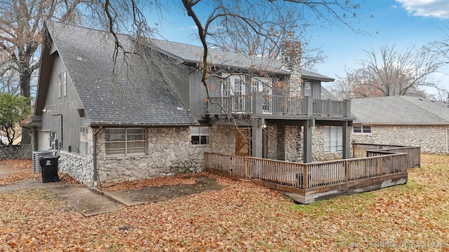 back of house featuring a wooden deck