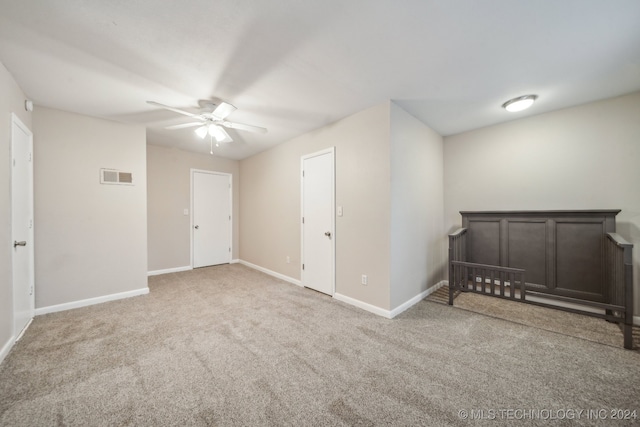 unfurnished bedroom featuring visible vents, baseboards, carpet, and ceiling fan