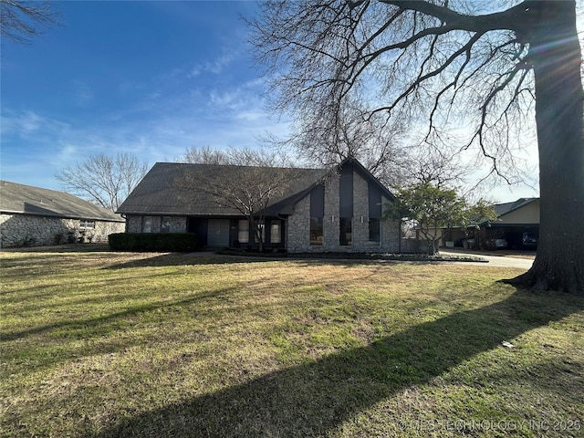 view of front of property featuring a front lawn and stone siding