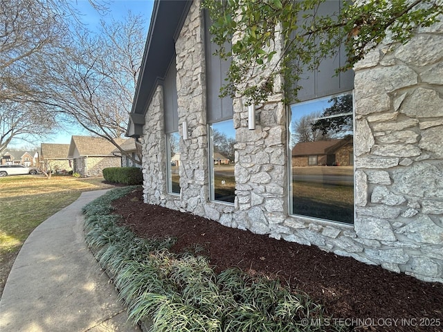 view of side of property featuring stone siding