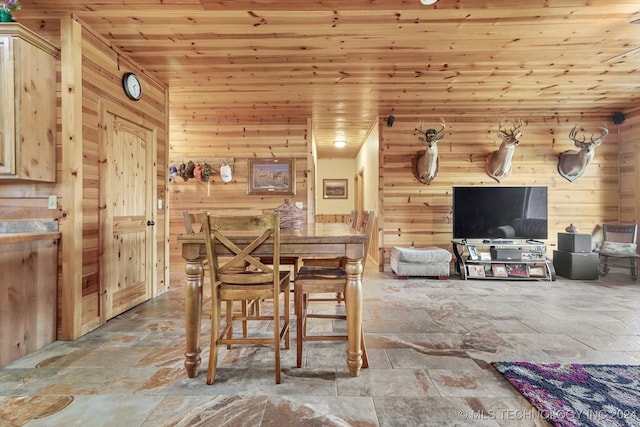 dining area with wooden walls and wood ceiling