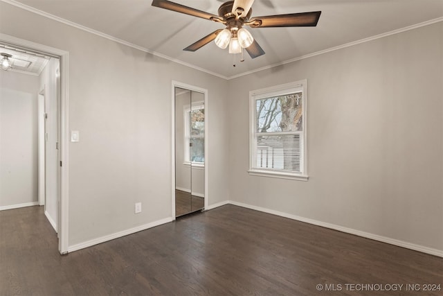 spare room featuring dark hardwood / wood-style flooring, ceiling fan, and crown molding