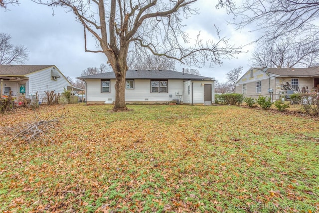 rear view of property featuring a yard