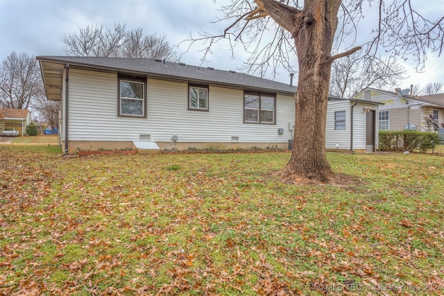 view of side of home with a yard