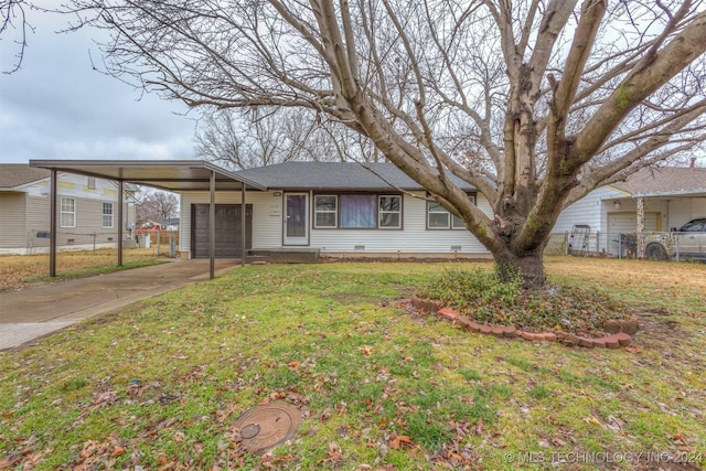 view of front of house featuring a carport, a garage, and a front lawn