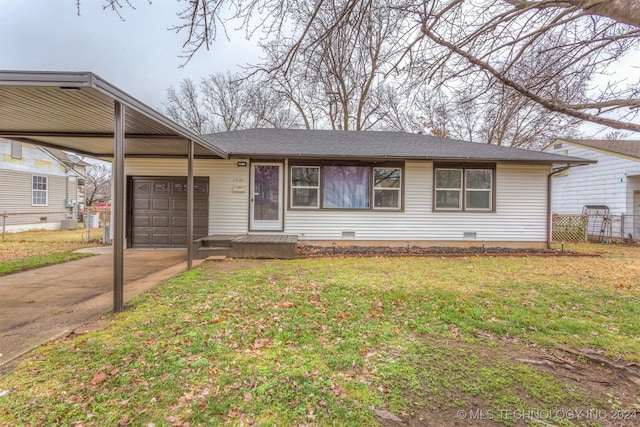 ranch-style home featuring a carport, a garage, and a front yard