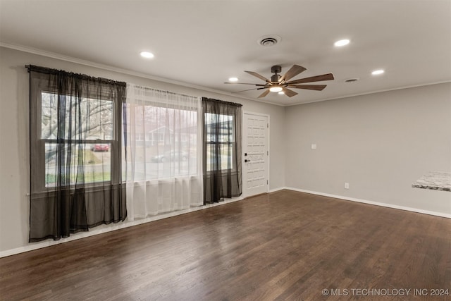 unfurnished room featuring dark hardwood / wood-style floors, ceiling fan, and ornamental molding