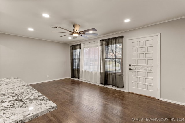 foyer with ceiling fan, dark hardwood / wood-style flooring, and crown molding