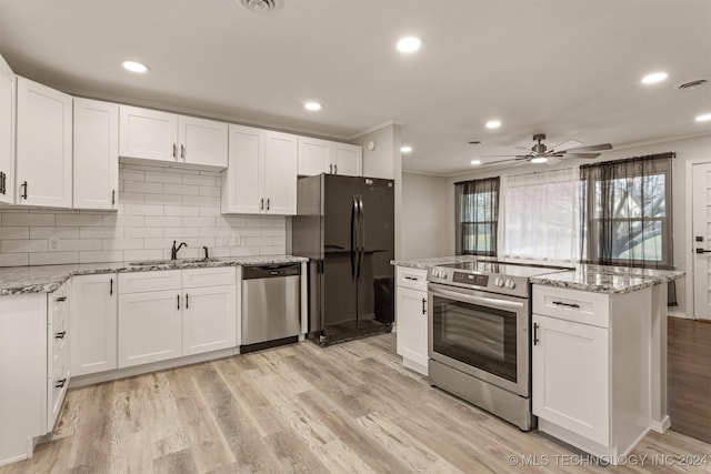 kitchen featuring white cabinets, light wood-type flooring, stainless steel appliances, and sink