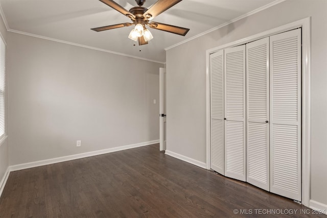 unfurnished bedroom featuring dark hardwood / wood-style floors, a closet, ornamental molding, and ceiling fan