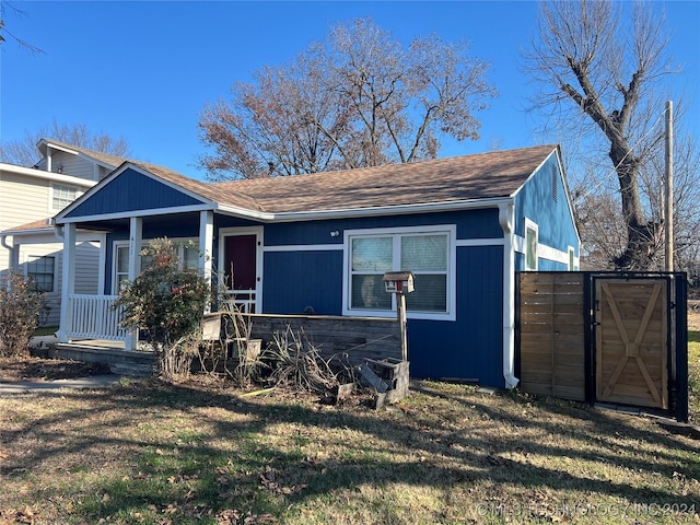 view of front of property with covered porch and a front lawn