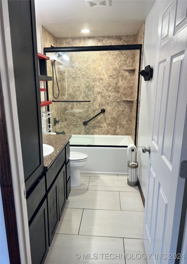 full bathroom featuring tile patterned flooring, vanity, toilet, and combined bath / shower with glass door