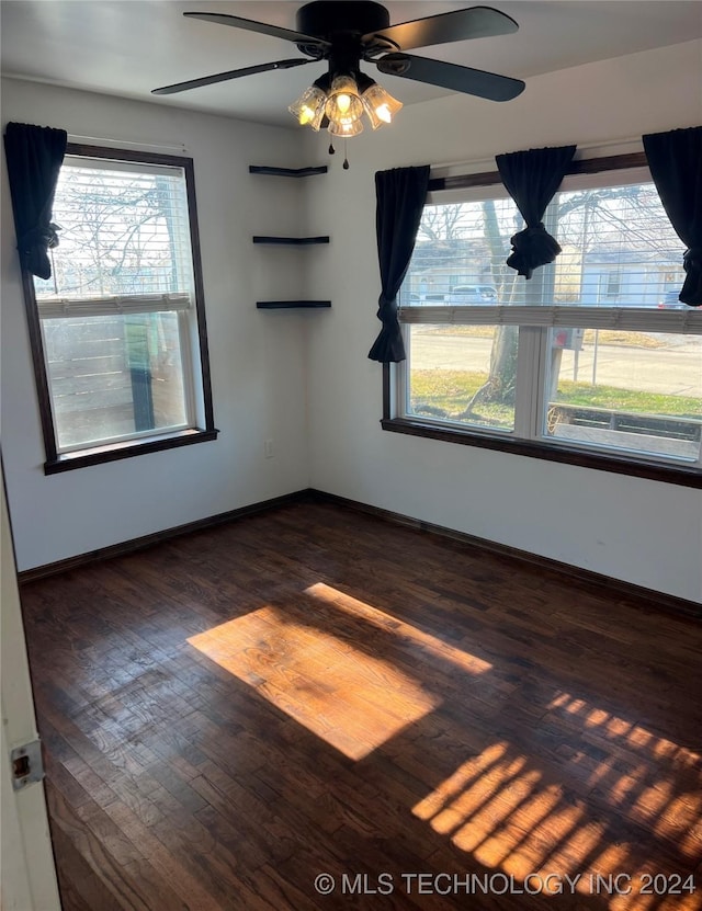 empty room featuring ceiling fan and dark hardwood / wood-style floors