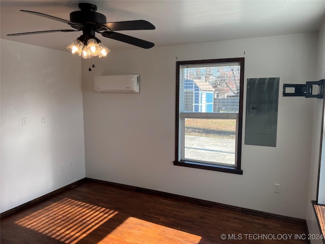 empty room with a wall mounted air conditioner, wood-type flooring, electric panel, and ceiling fan