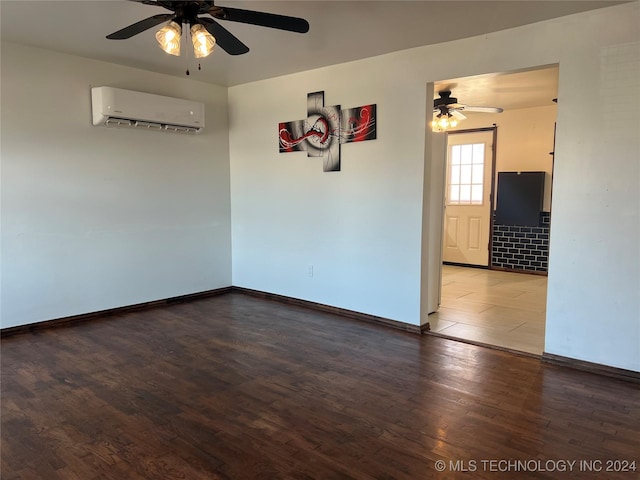 empty room featuring a wall unit AC, ceiling fan, and hardwood / wood-style flooring