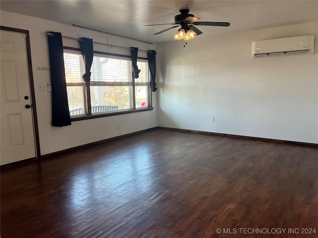 empty room with dark hardwood / wood-style floors, ceiling fan, and a wall unit AC