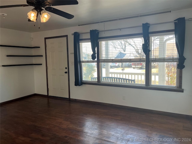 unfurnished room featuring dark hardwood / wood-style flooring and ceiling fan