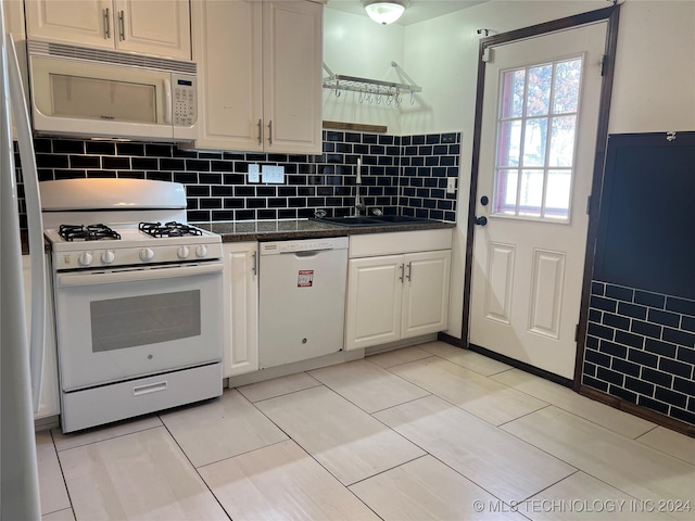 kitchen with sink, light tile patterned flooring, white appliances, decorative backsplash, and white cabinets