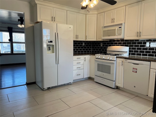 kitchen featuring white cabinets, light wood-type flooring, white appliances, and decorative backsplash