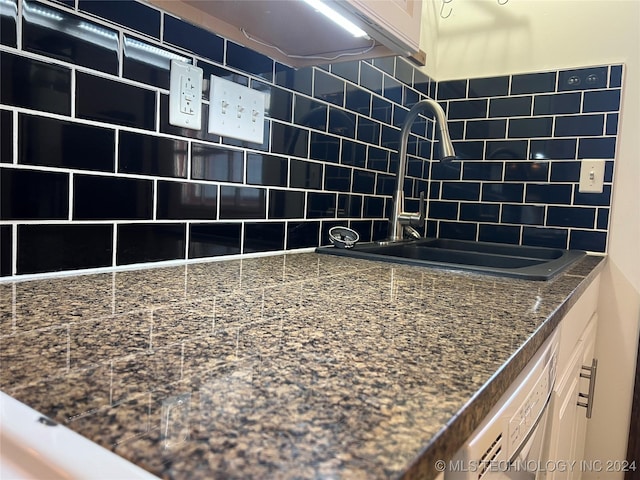 kitchen with dishwasher, tasteful backsplash, and sink