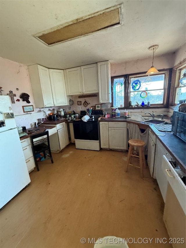 kitchen featuring sink, electric range, white cabinets, decorative light fixtures, and white fridge