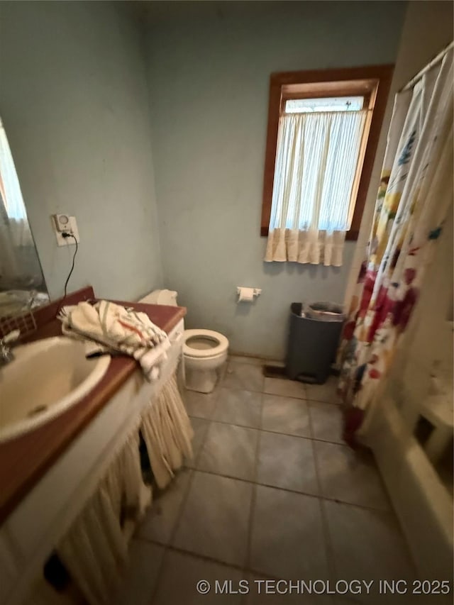 bathroom with tile patterned flooring, sink, and toilet