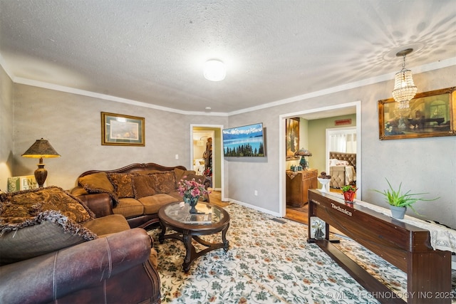 living room featuring a textured ceiling, ornamental molding, and an inviting chandelier