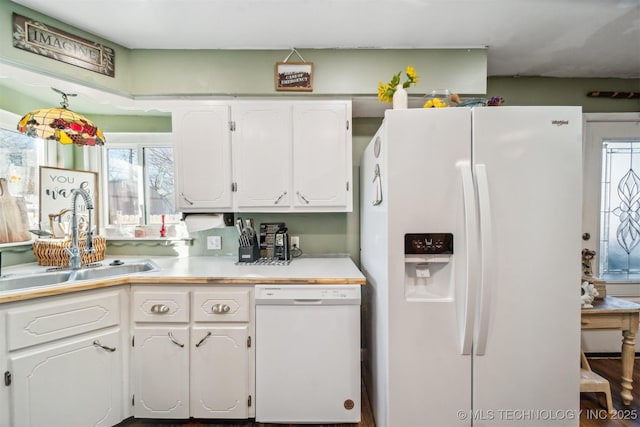 kitchen with white appliances, white cabinets, and sink