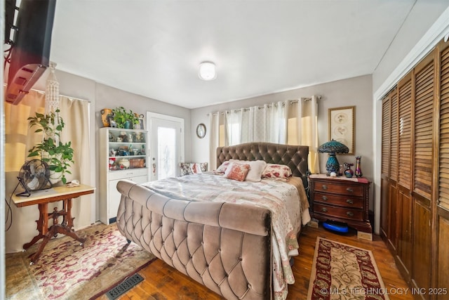 bedroom featuring a closet and dark hardwood / wood-style flooring