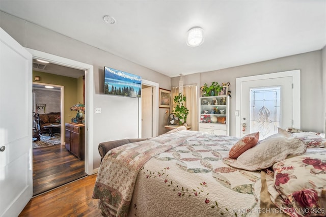 bedroom with dark wood-type flooring