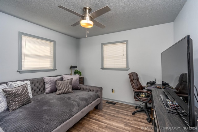 office space with hardwood / wood-style floors, a textured ceiling, and ceiling fan