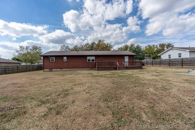 back of house with a yard and a wooden deck