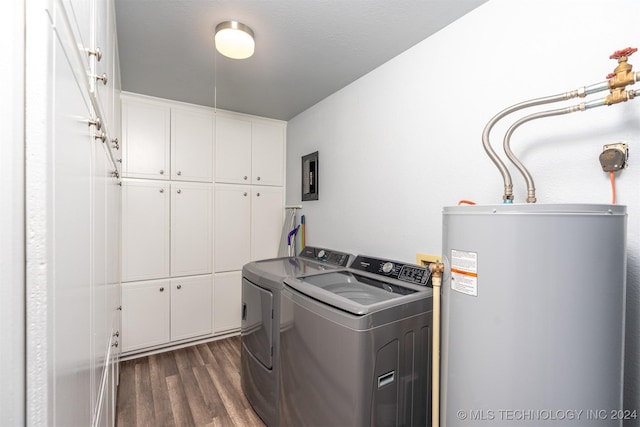 laundry room featuring dark hardwood / wood-style floors, cabinets, gas water heater, and independent washer and dryer